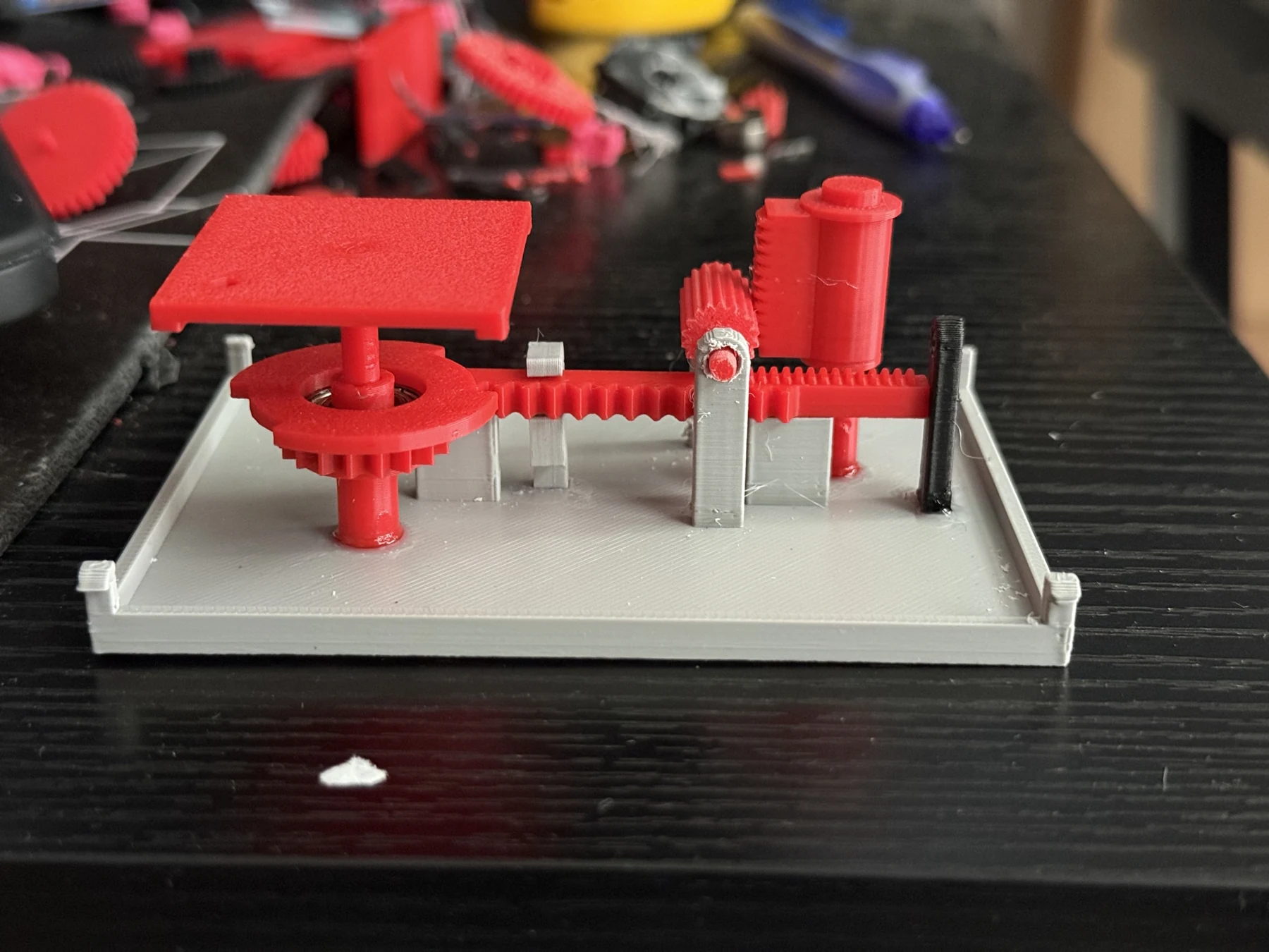Physical FDM prototype with the housing removed, exposing the tile and reset mechanism.